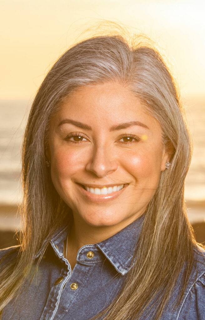 Sandra K Carlsbad Realtor Specializing in Relocation, standing on the beach.